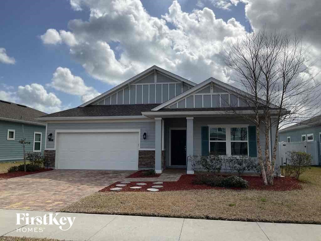 the front of a house with a driveway and a garage door