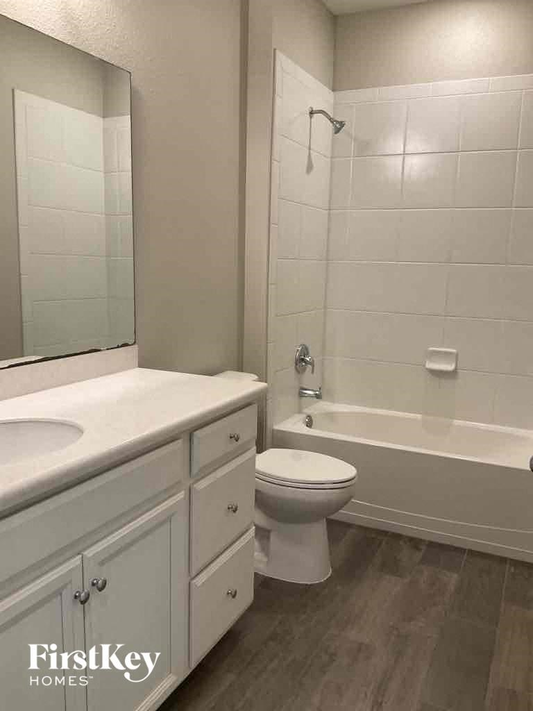 a bathroom with a toilet and a tub and a sink