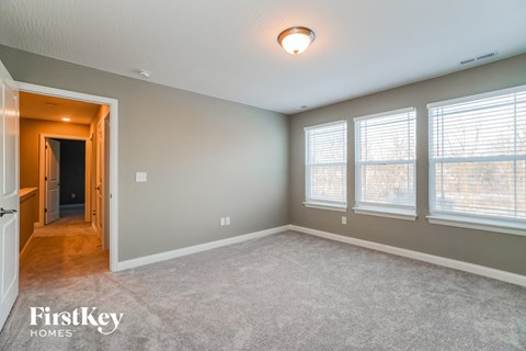 the master bedroom is spacious and has a walk in closet and a large window