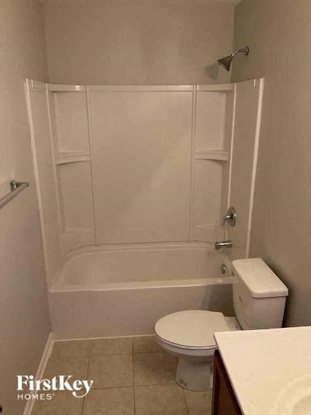 a white bathroom with a toilet and a shower