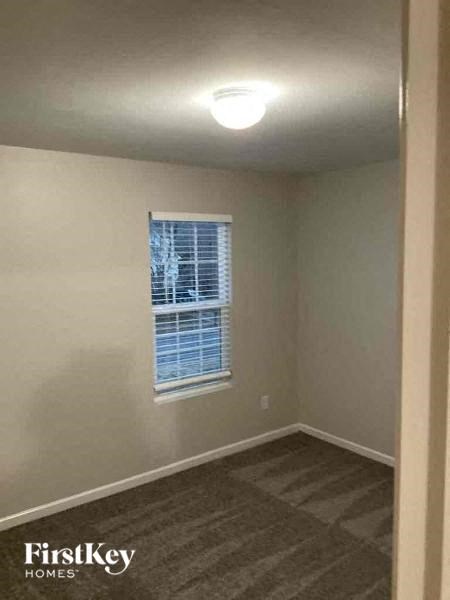 an empty room with a window and a light in it