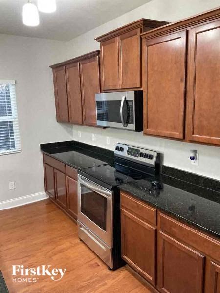 a kitchen with a stove and a microwave