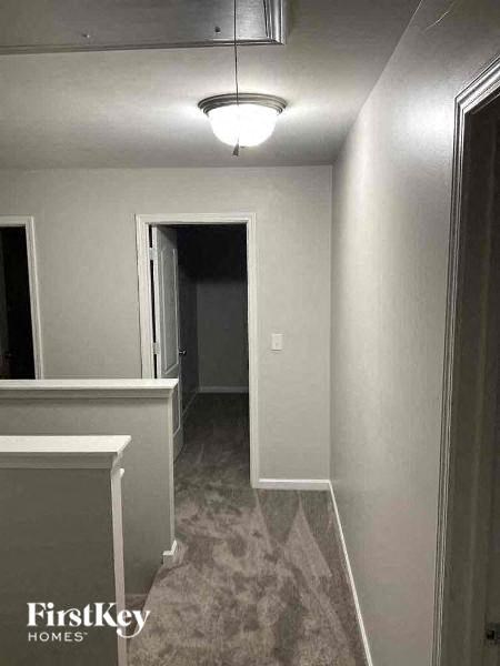 a hallway with a door and a light on the ceiling