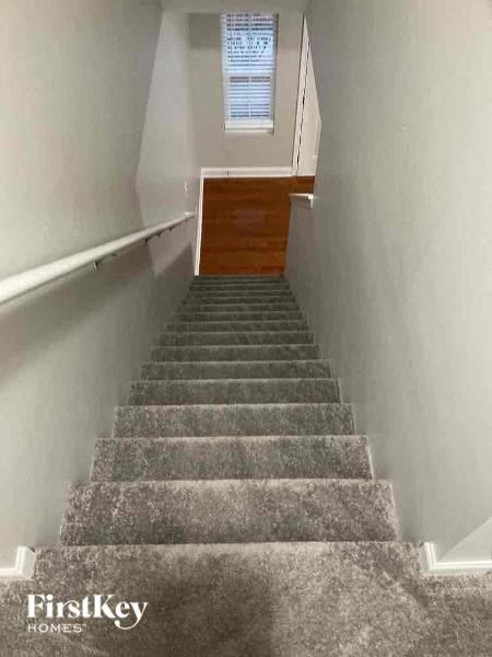 a flight of stairs with a wooden door at the top