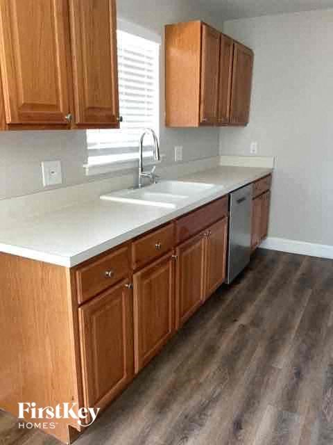 A kitchen with wooden cabinets and a white countertop.