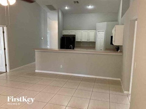 A kitchen area with a counter and cabinets.