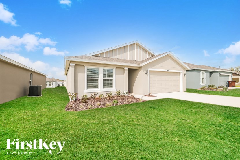 A house with a lawn in front of it and the words "Firstkey Homes" on the bottom left.