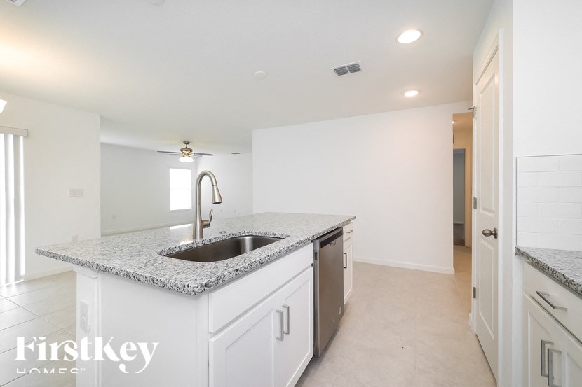 A kitchen with a granite countertop and a sink.