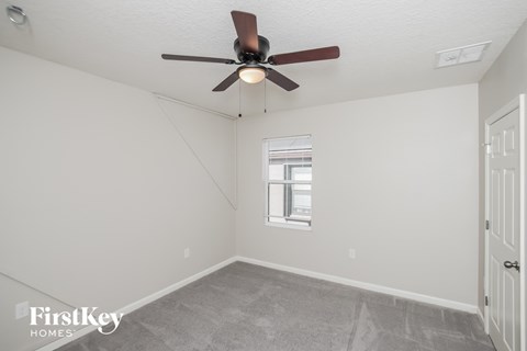 a living room with a ceiling fan and a window