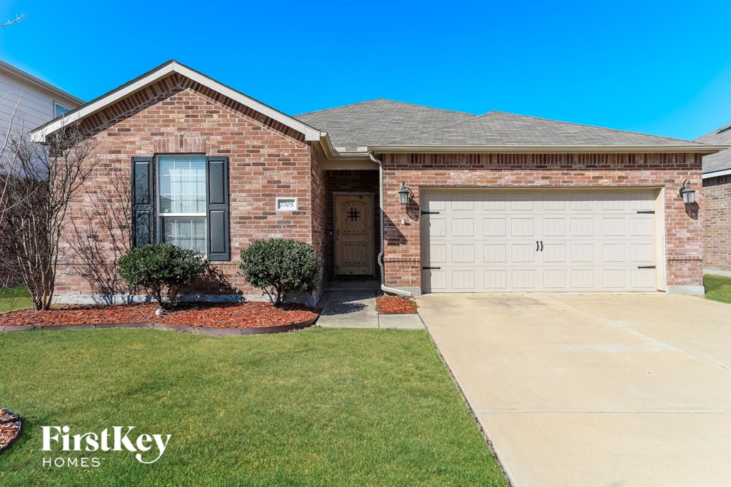 a brick house with a white garage door