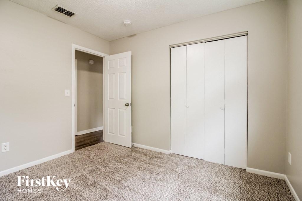 a bedroom with a closet and a door to a closet