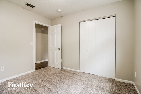 a bedroom with a closet and a door to a closet