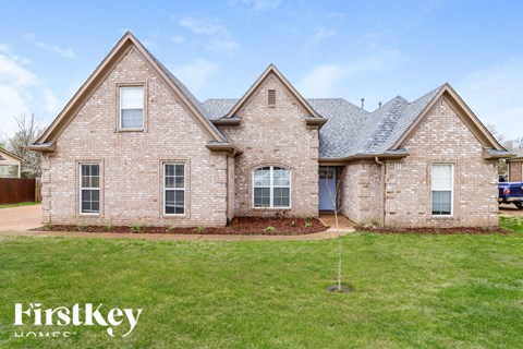 A brick house with a blue sky in the background.