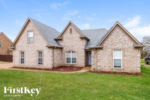 A brick house with a blue sky in the background.