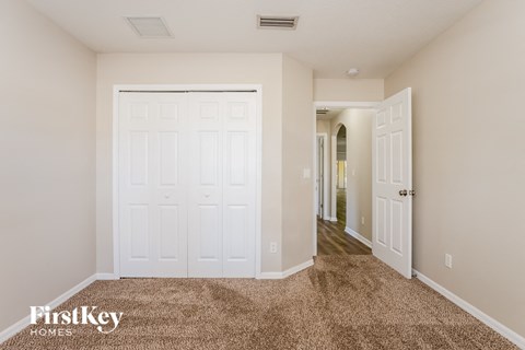 a bedroom with two closets and a door to a hallway