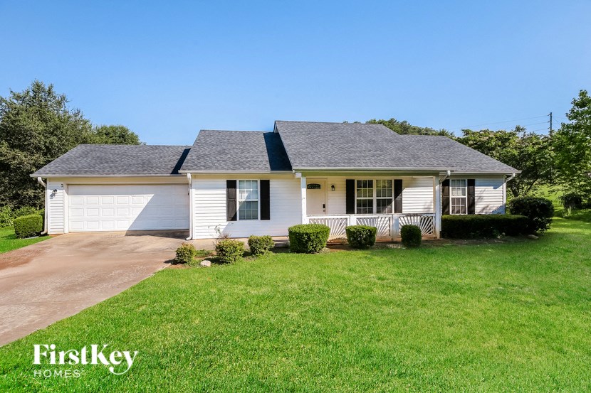 a white house with a lawn in front of it