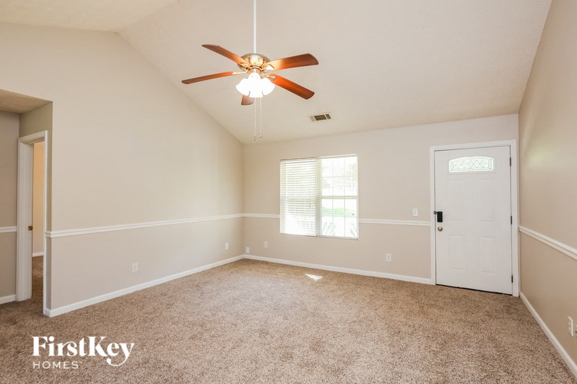 a bedroom with a ceiling fan and a white door