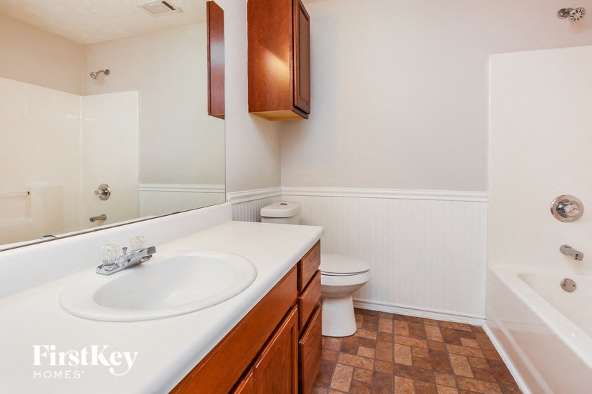 a bathroom with a sink and a toilet and a mirror