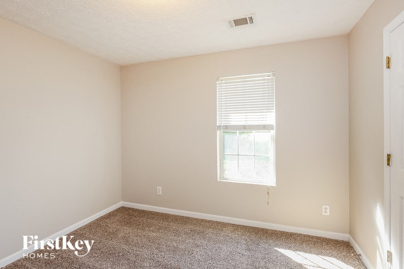 a room with carpet and a window and a door