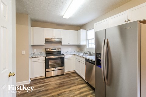 a kitchen with stainless steel appliances and white cabinets