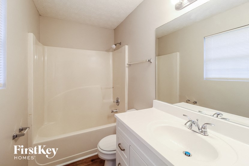 a bathroom with a sink and a toilet and a shower