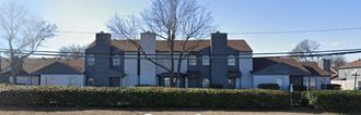 a large house with a fence in front of it