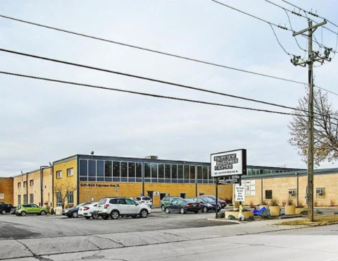 a large yellow building with cars parked in front of it