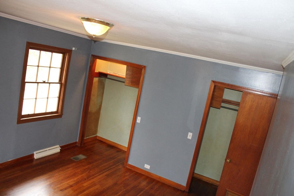 an empty room with blue walls and a window and a door