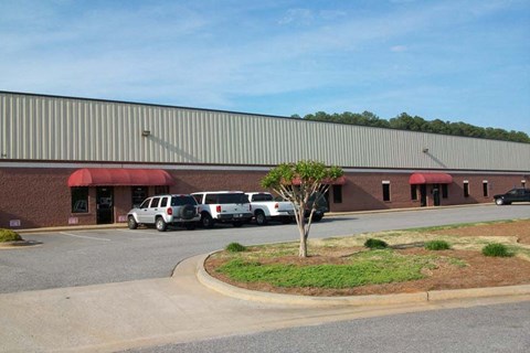 a parking lot with cars in front of a building
