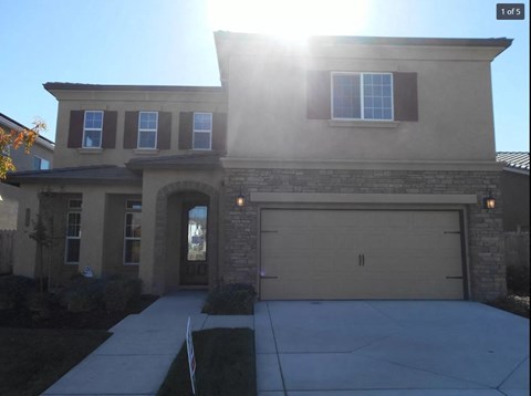 A house with a garage and a driveway.