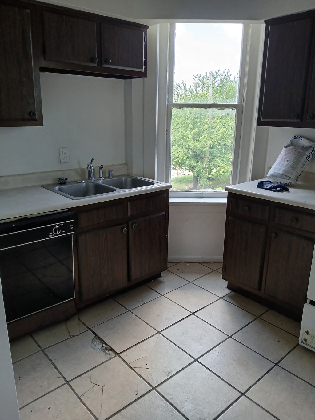 an empty kitchen with a sink and a window