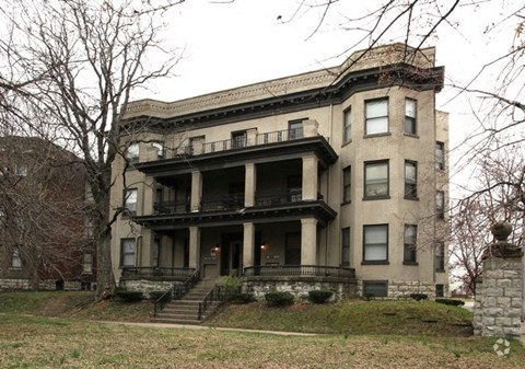 an old house with a lot of stairs and a porch