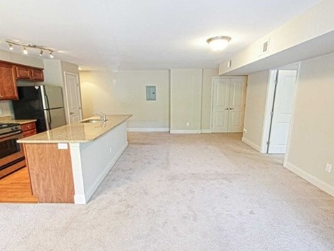 A kitchen with a refrigerator, microwave, and oven.