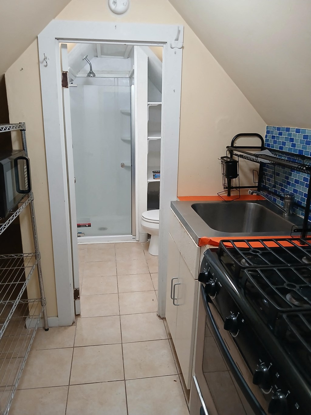 A kitchen with a stove top oven and a microwave.