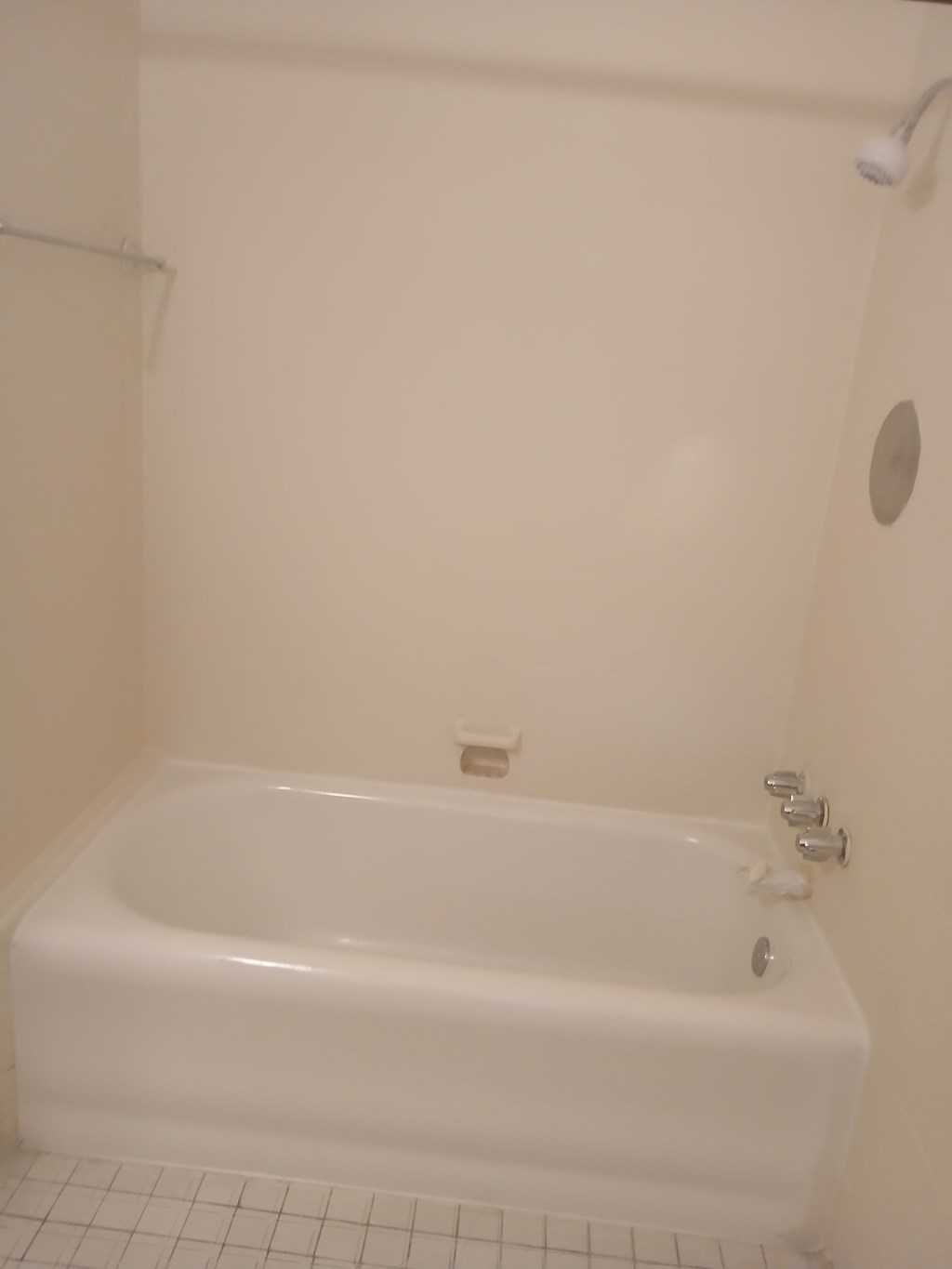 a bathroom with a white tub and a shower