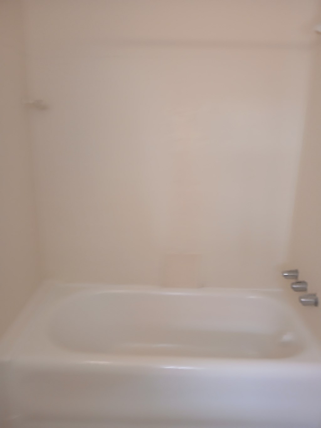 a white bath tub in a bathroom with a sink