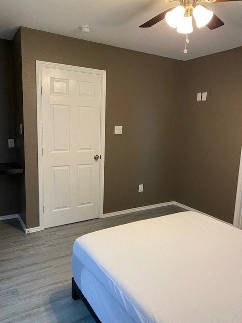 a bedroom with a white bed and a white door