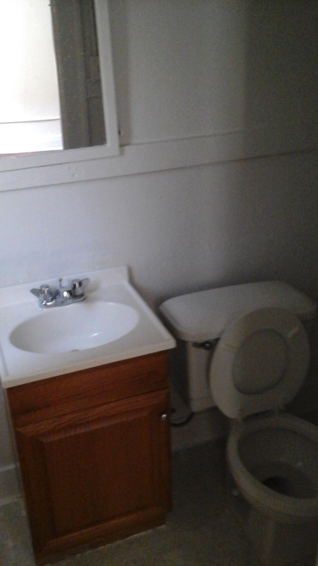 a bathroom with a toilet and a sink and a mirror