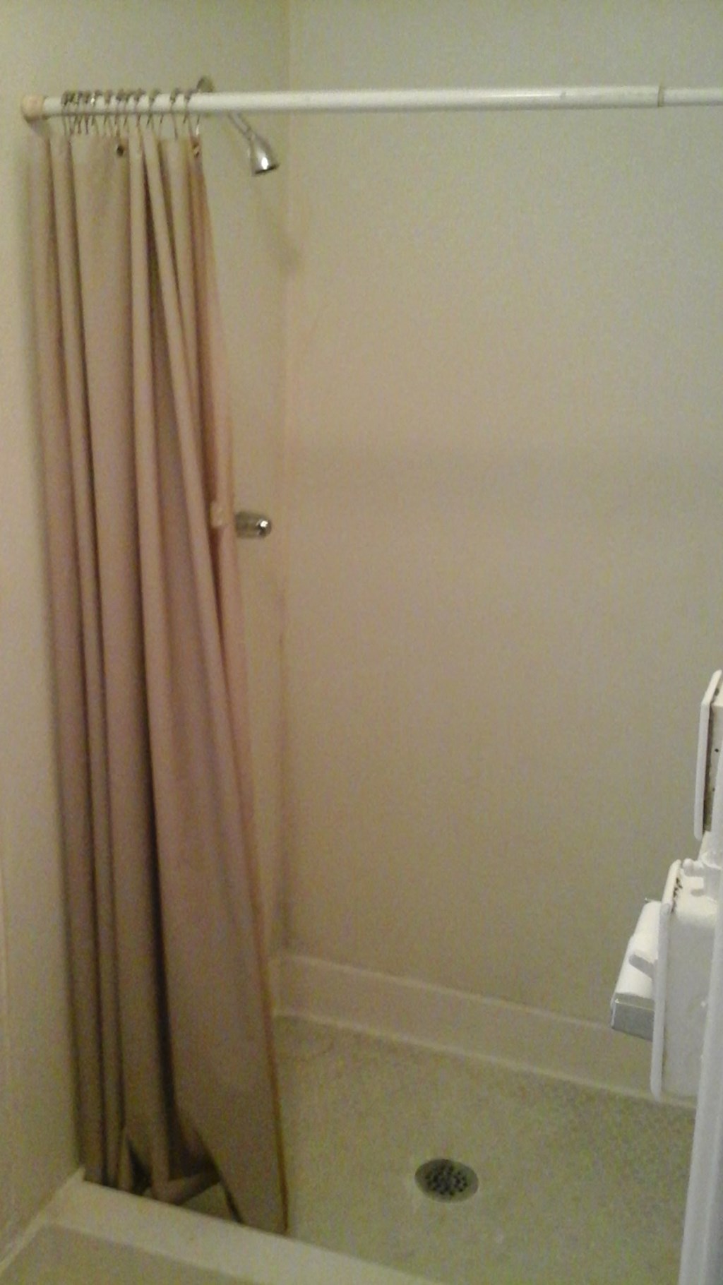 a shower in a bathroom with a shower curtain