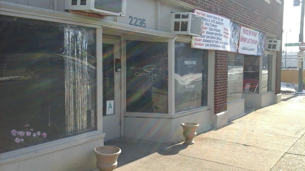 the front of a building with signs in the window