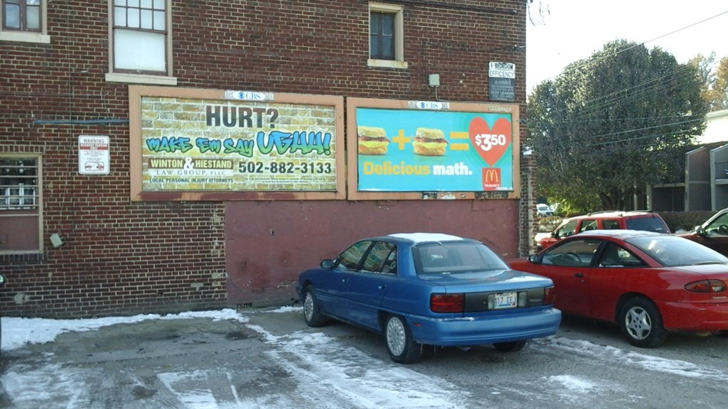 a blue car parked in front of a building