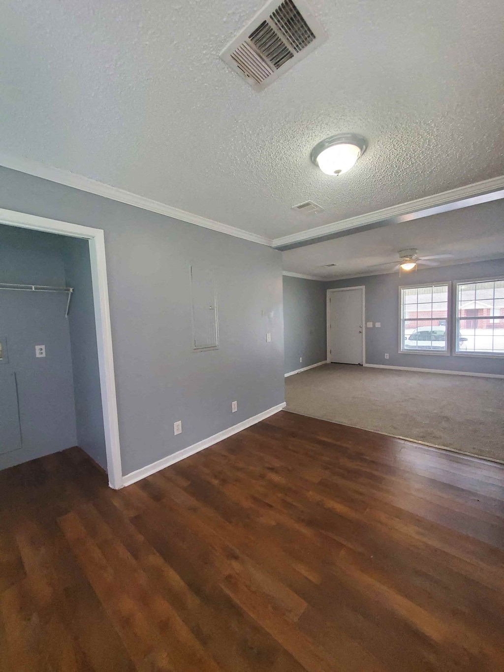 an empty living room with a hard wood floor
