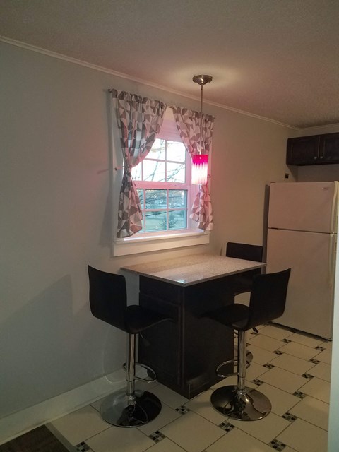 an image of a kitchen with a table and chairs