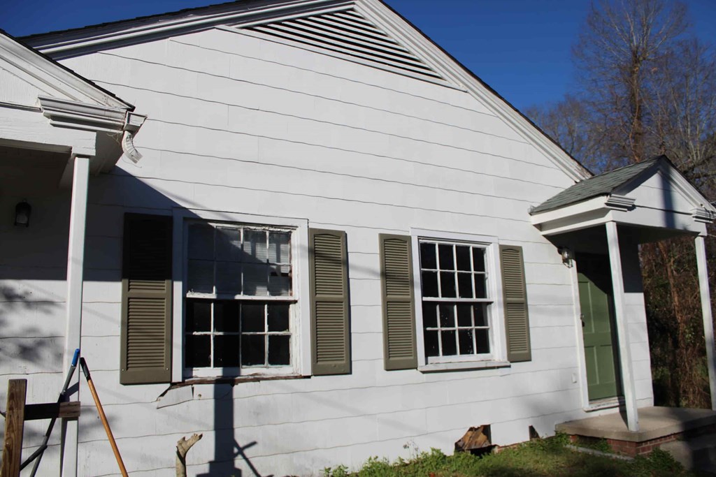 the front of the house with the shutters open
