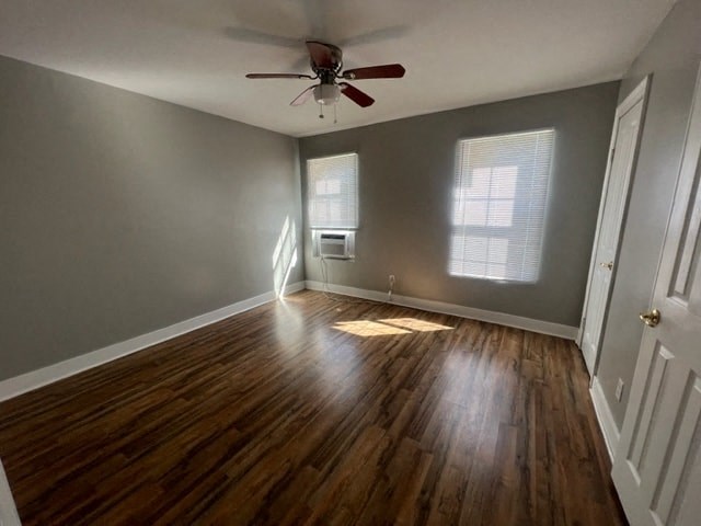 a living room with wood floors and a ceiling fan