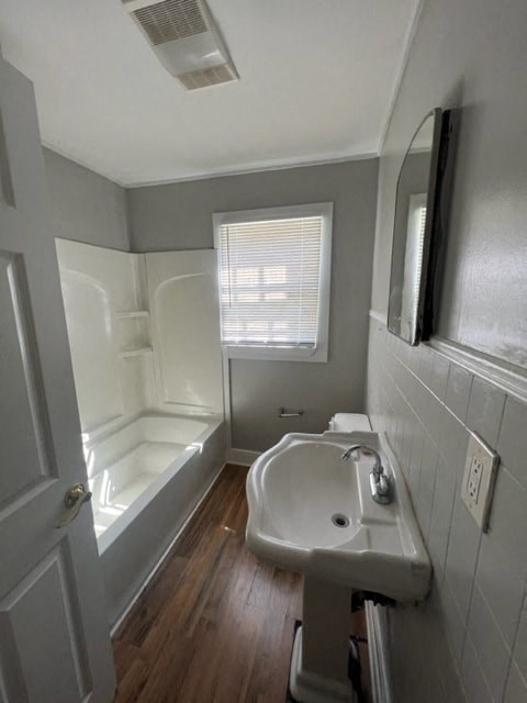 a small bathroom with a sink and a tub