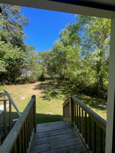 a view of a backyard from a wooden staircase