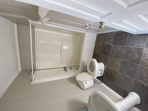 a small bathroom with a toilet and a shower