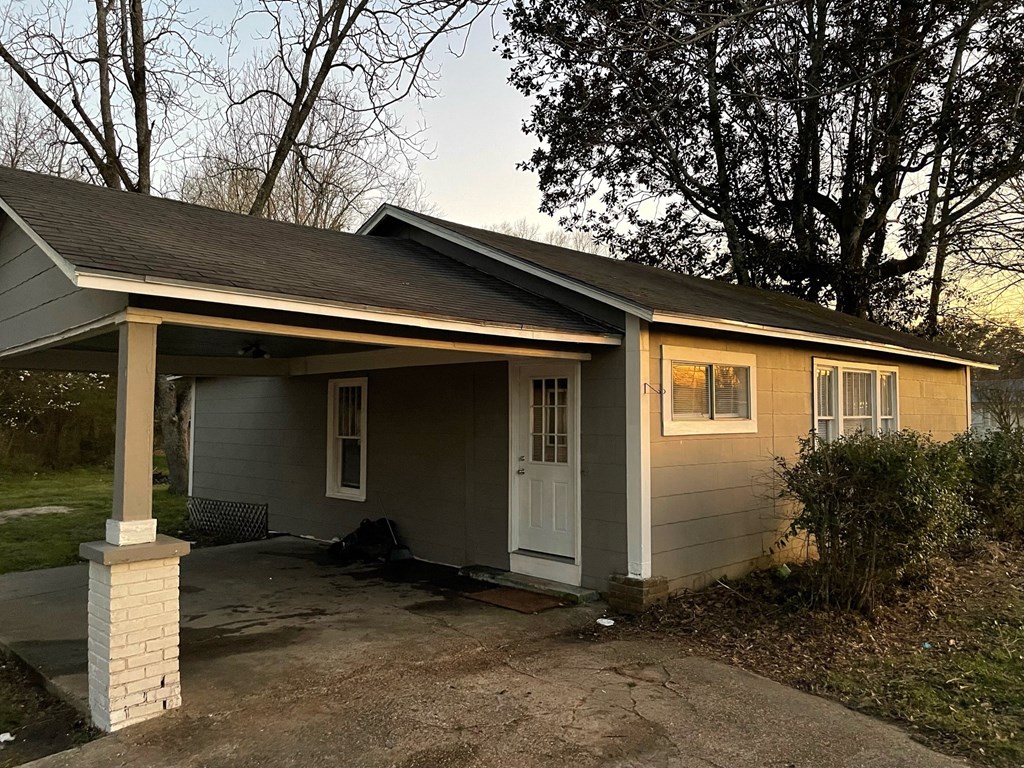 a home with a covered porch and a driveway