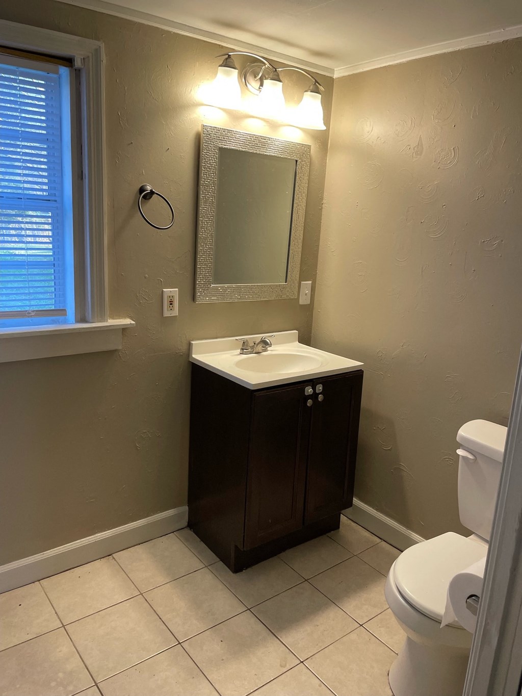 a bathroom with a sink and a toilet and a mirror